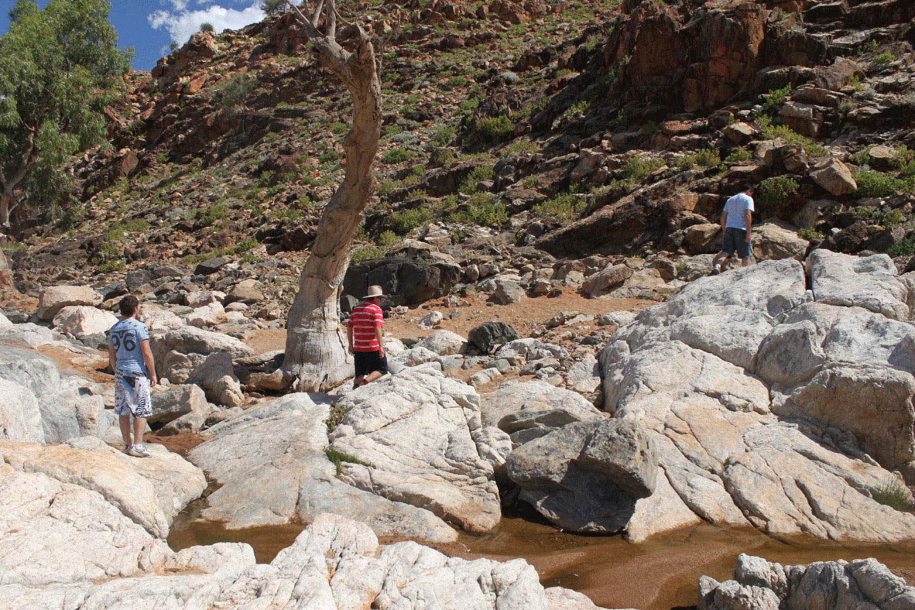 Visitors walking among white rocks in Eldee Creek Gorge