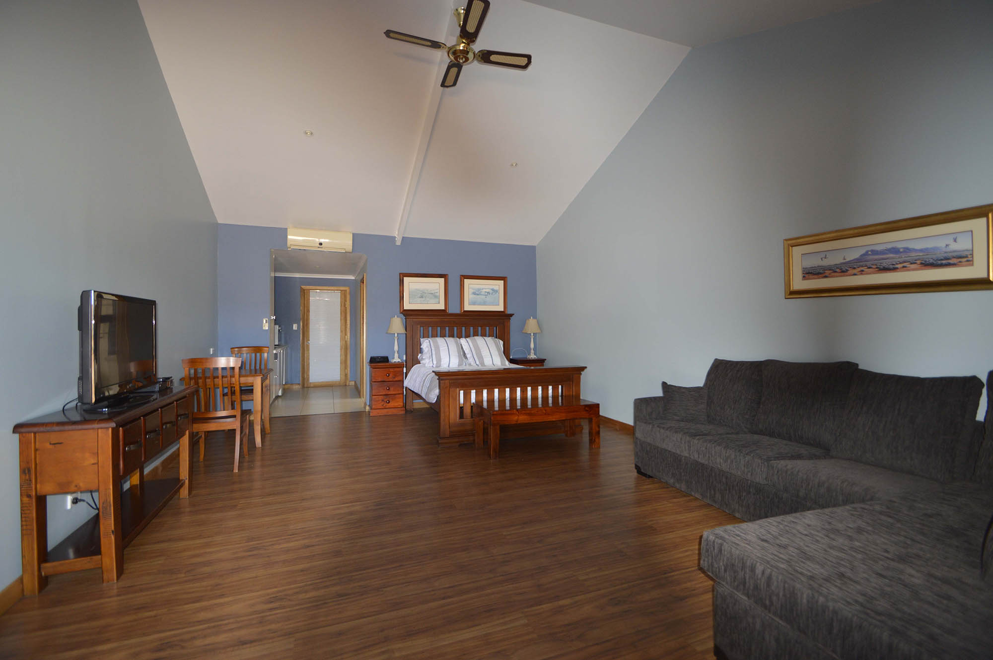 Mt Robe room with a bed, sofa, dining area and kitchenette