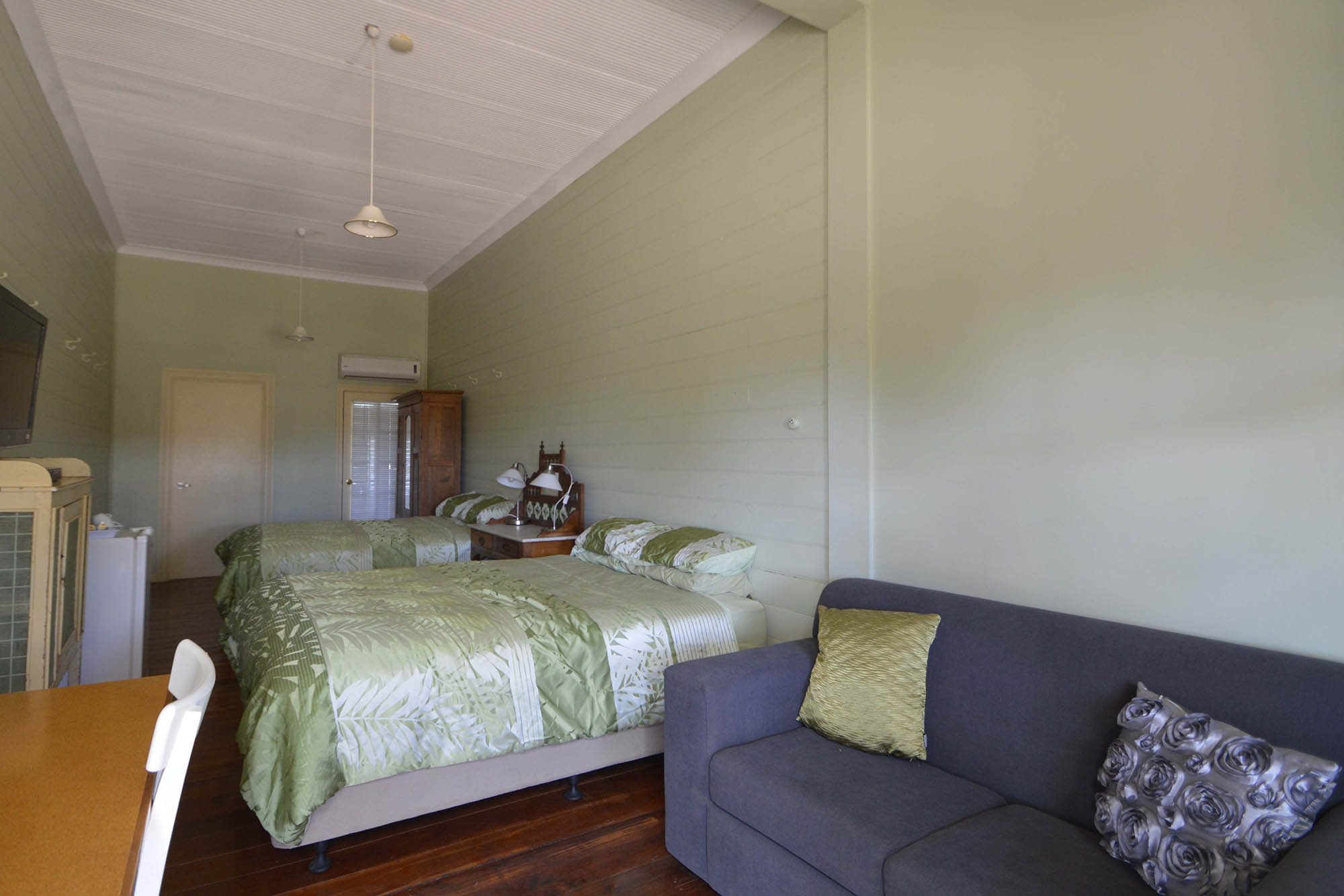 Standard Room 2 with a bed, sofa and dining table